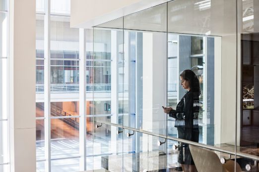 businesswoman-standing-in-a-conference-room-window-2023-11-27